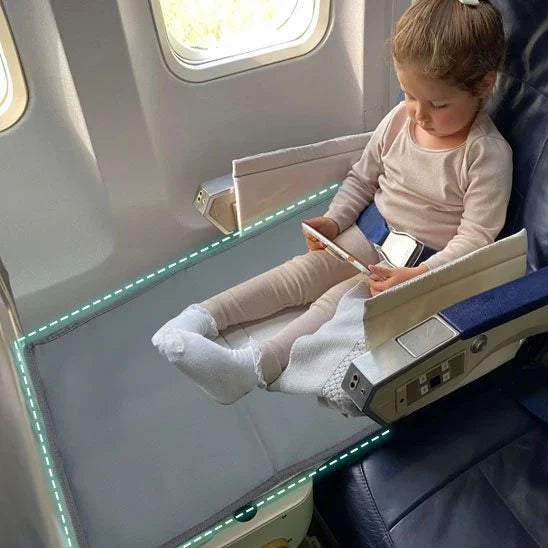 Toddler using airplane bed extender for comfortable travel, safe sleep solution for kids on flights