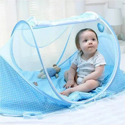 Baby sitting in blue polka-dot playpen with soft toys, ensuring safe and cozy playtime.
