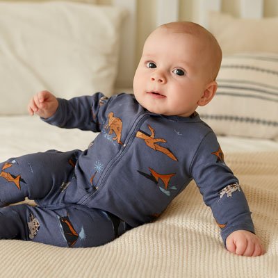 Baby in cozy blue dinosaur pajamas for sweet, peaceful sleep