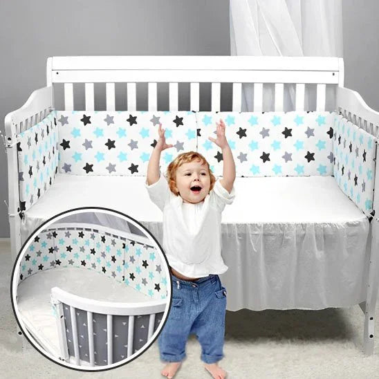 Happy baby in white crib with star-patterned bumper, soft bedding for safe, cozy sleep