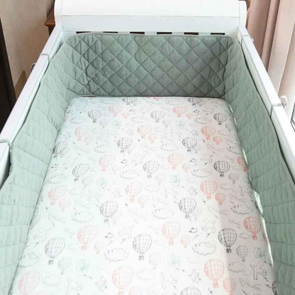 Mint green quilted crib bumper with hot air balloon print sheet for baby's cozy sleep
