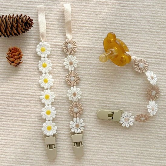 Floral pacifier clips with daisy designs for baby comfort and style