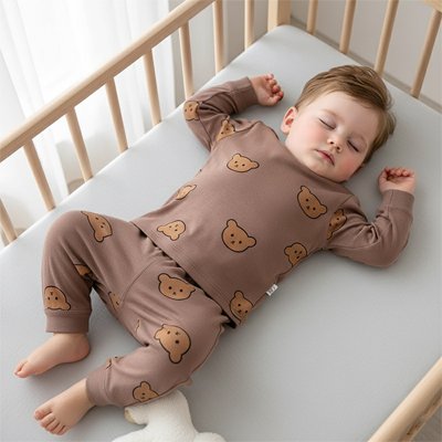 Baby sleeping peacefully in cozy bear-print pajamas on soft crib mattress, ideal for gentle nights