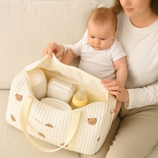 Baby essentials in cute teddy bear diaper bag, perfect for nursery or travel with newborns