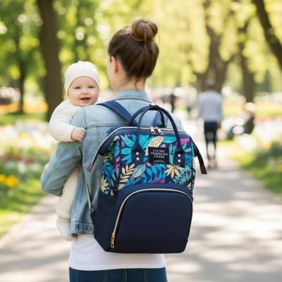 Mother carrying baby with floral diaper bag in park, perfect for baby essentials and comfort