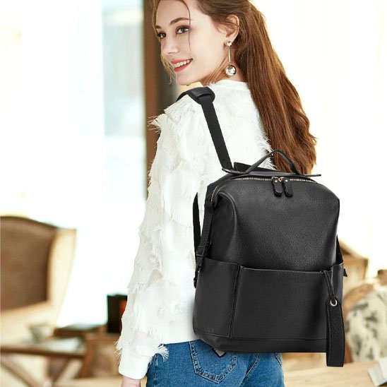 Stylish black leather backpack for women, perfect for daily use or travel, featuring front pocket and adjustable straps.