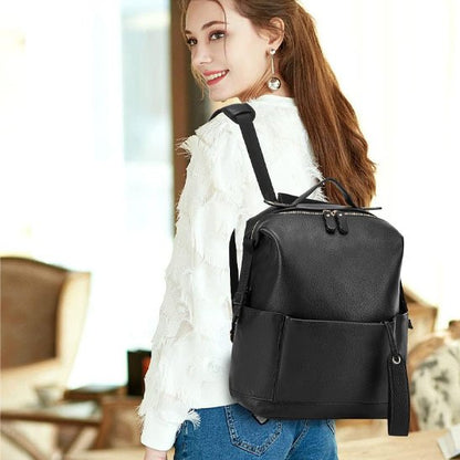 Stylish black leather backpack for women, perfect for daily use or travel, featuring front pocket and adjustable straps.