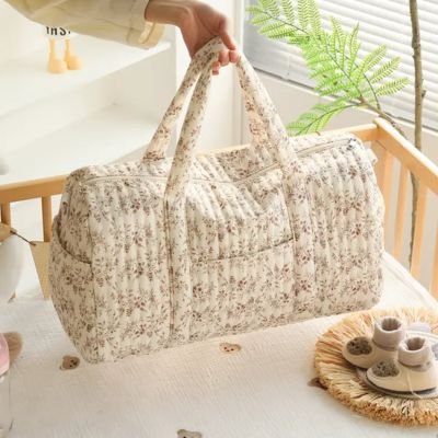 Floral quilted diaper bag with handles, perfect for baby essentials and nursery organization