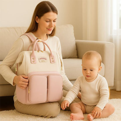 Mom holding stylish pink diaper bag with baby sitting nearby, cozy home setting