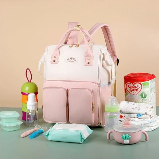 Pink baby diaper bag with nursery essentials for comfortable baby care and soothing nights