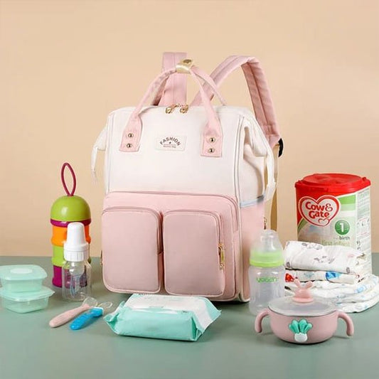 Pink baby diaper bag with nursery essentials for comfortable baby care and soothing nights