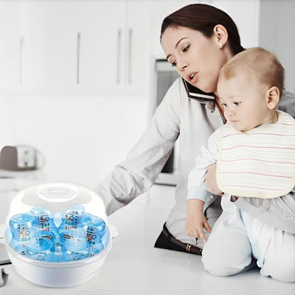 Mother holding baby near baby bottle sterilizer in modern kitchen