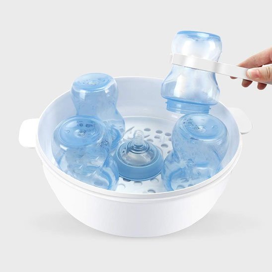Baby bottle sterilizer with blue bottles and nipples, steam sterilizing for safe feeding