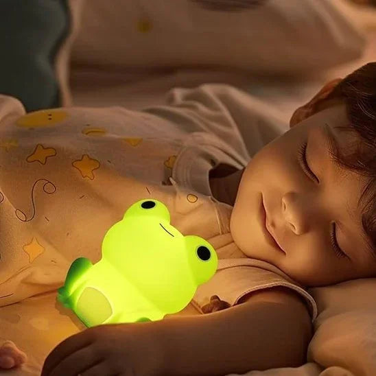 Cute frog night light glowing beside sleeping baby, cozy bedtime ambiance for gentle sleep