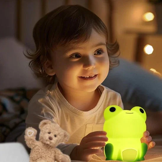 Child holding glowing frog night light for cozy bedtime, soft illumination for baby sleep comfort