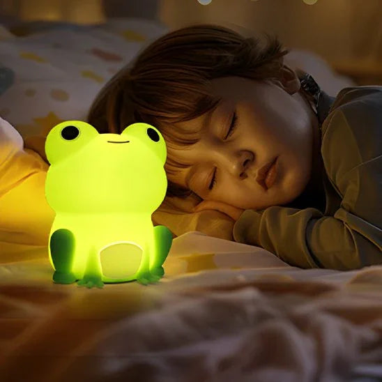 Cute frog night light glowing softly beside sleeping child for cozy bedtime ambiance