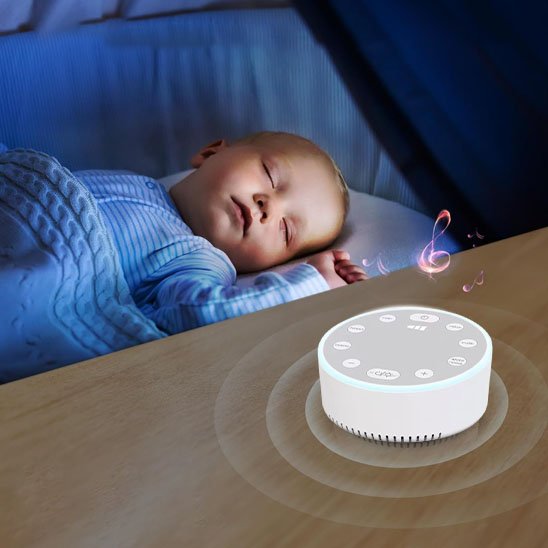 Baby sleeping peacefully with white noise machine playing lullabies for calm nights