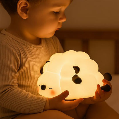 Child holding cute cloud-shaped night light for cozy baby sleep